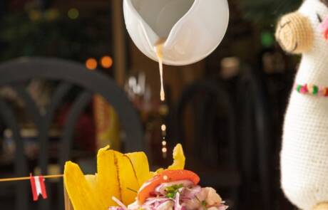 Chef,Pouring,Leche,De,Tigre,Marinade,On,A,Plate,Of