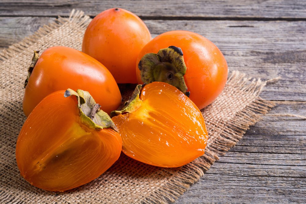 Delicious,Ripe,Persimmon,Fruit,On,Wooden,Background