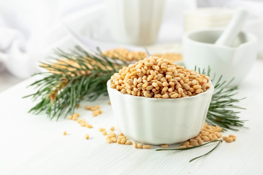 Peeled,Pine,Nuts,On,A,White,Wooden,Table.,Pine,Nuts